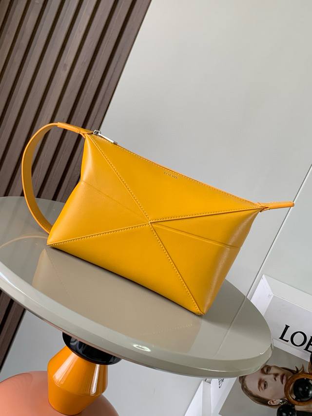 New Model With A Glossy Leather Finish, The Puzzle Fold Toiletry Bag Draws Inspi