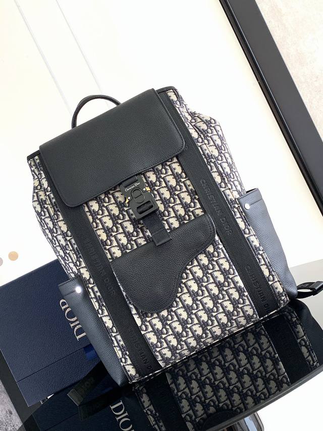 Practical And Elegant, This Saddle Backpack Is Crafted From Beige And Black Obli