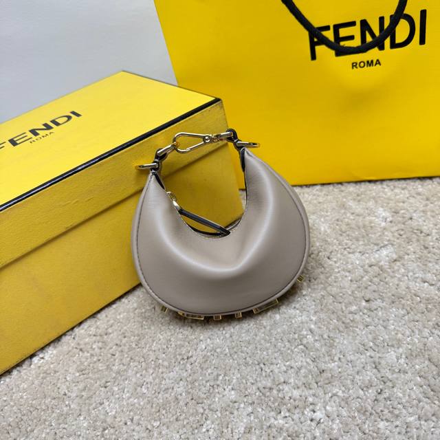 Small Gray Praphy Underarm Bag, Featuring A Crescent Shape, With The Classic Met