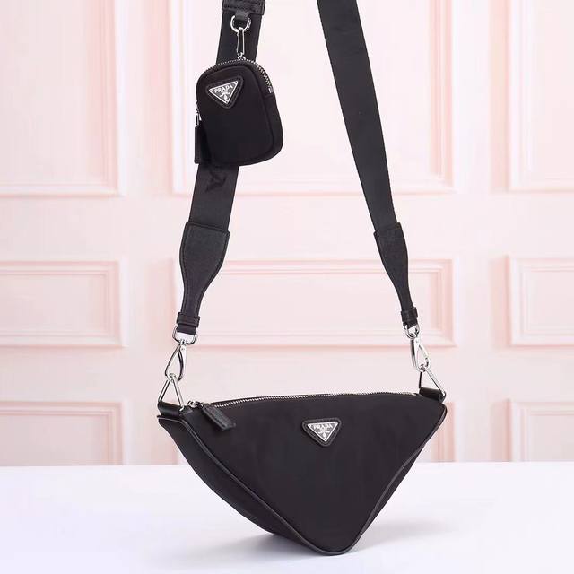 Prada - Prada's Latest Triangular Crossbody Bag, Officially Synchronized. Made W