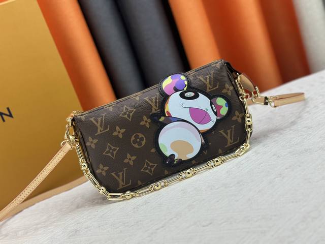 M13440 This Pochette Accessoires Handbag Is Crafted From Monogram Coated Canvas,