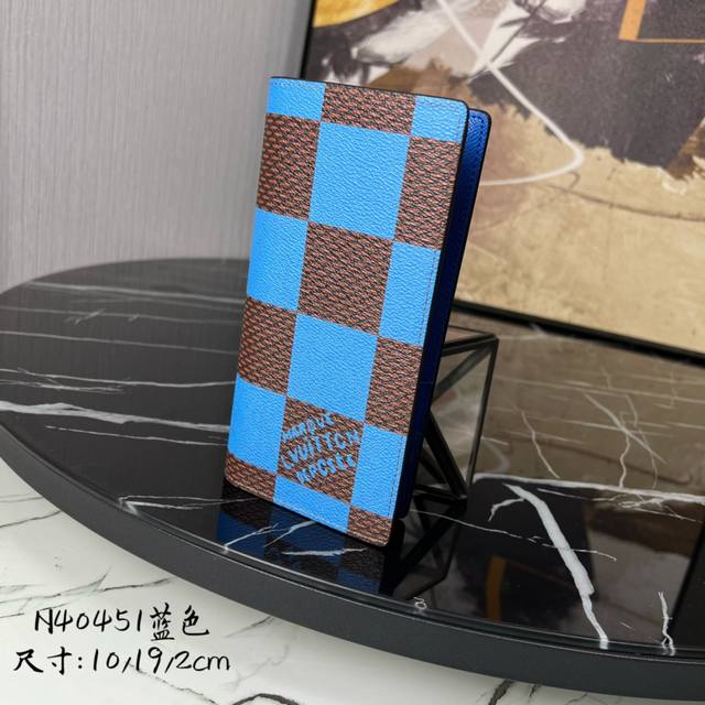 M14110 The green Brazza Long Wallet is made of colorful Monogram coated canvas a