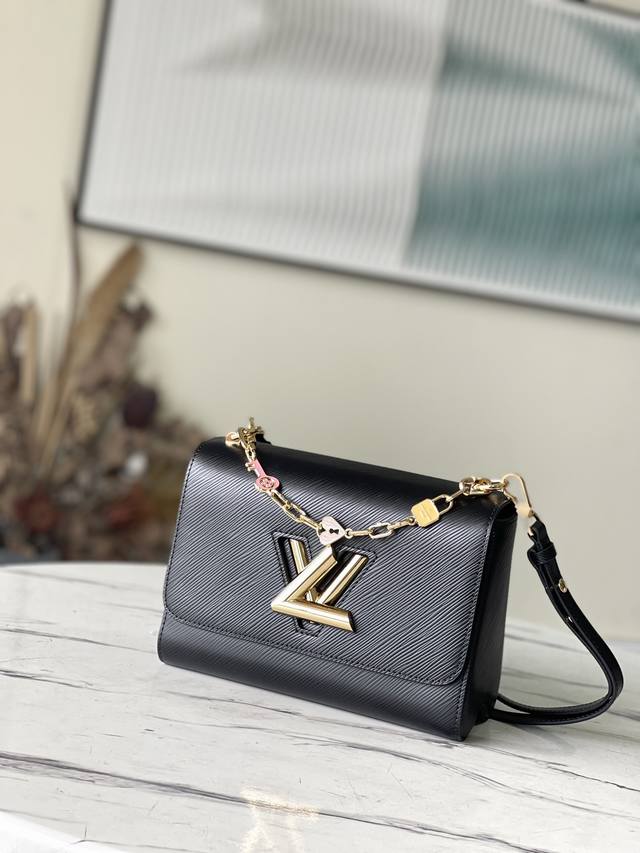 Top-grain leather original M20834 Black This Twist medium handbag is made of gra