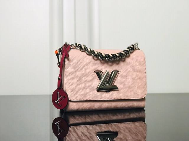 M52504 Pink Top Original The Twist medium handbag matches the new winter look of