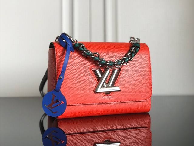 M52504 Red Top Original The Twist medium handbag matches the new winter look of