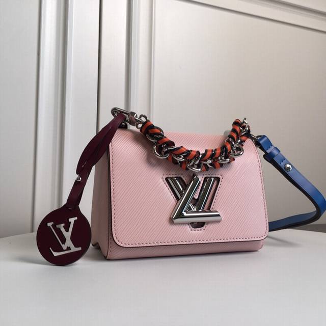 M52504 Pink Top Original The Twist Medium Handbag matches the new winter look of