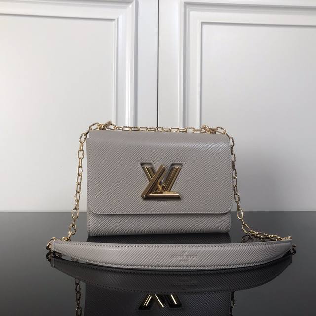 M21025 Grey ribbed lock top original This Twist medium handbag is made of Epi gr