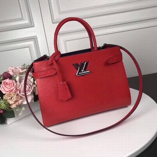 M54810 Red top original Twist Tote handbag This Twist Tote handbag has modern li
