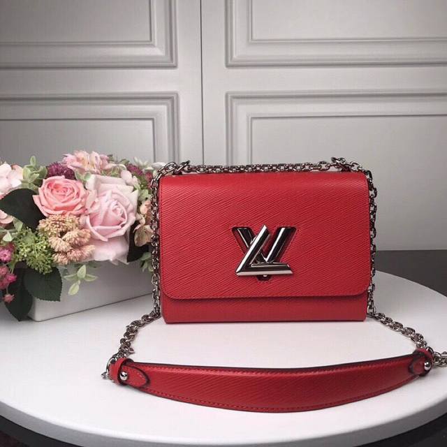 M50280 Red Top Original Twist Medium Handbag This chic small handbag hides a sec