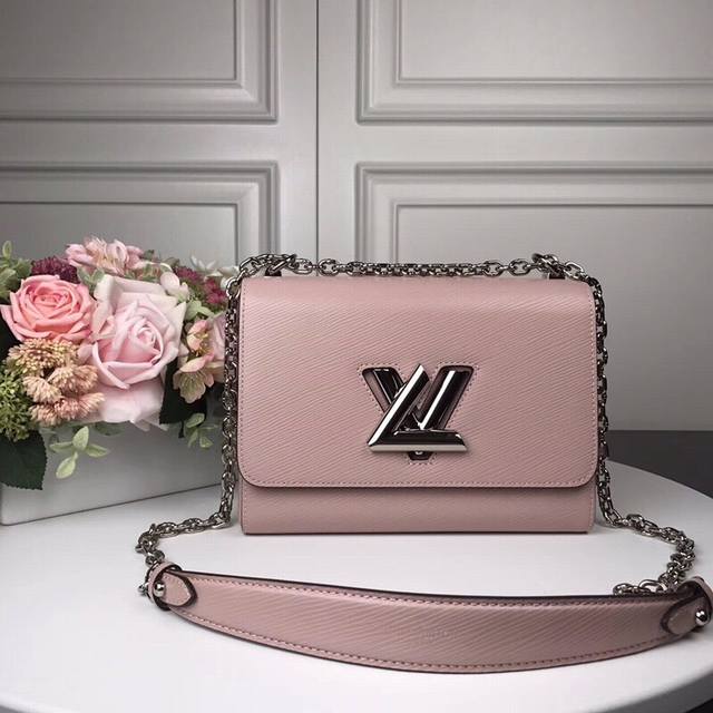 M50280 Pink Top Original Twist Medium Handbag This chic small handbag hides a se