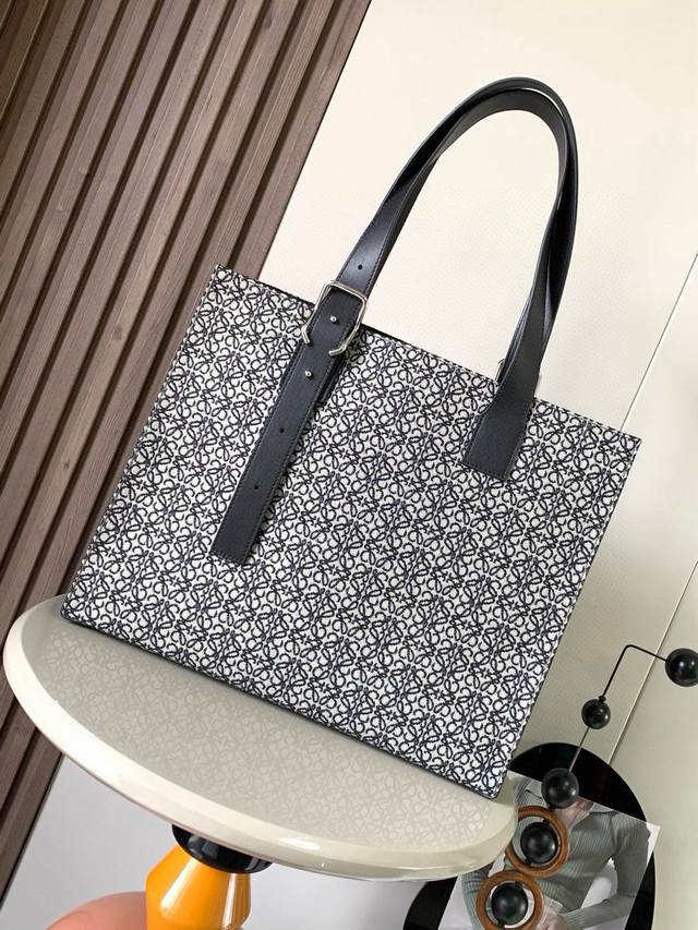 Loewe Buckle Tote is a slim and lightweight handbag with jacquard fabric handles