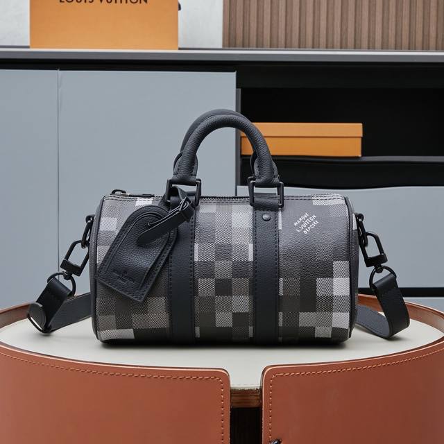 Exclusive real shot of the M14919 Speedy pillow bag in black camouflage pattern.