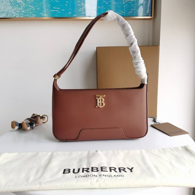 Burberry's exquisite shoulder bag is made of top-grain leather and decorated wit