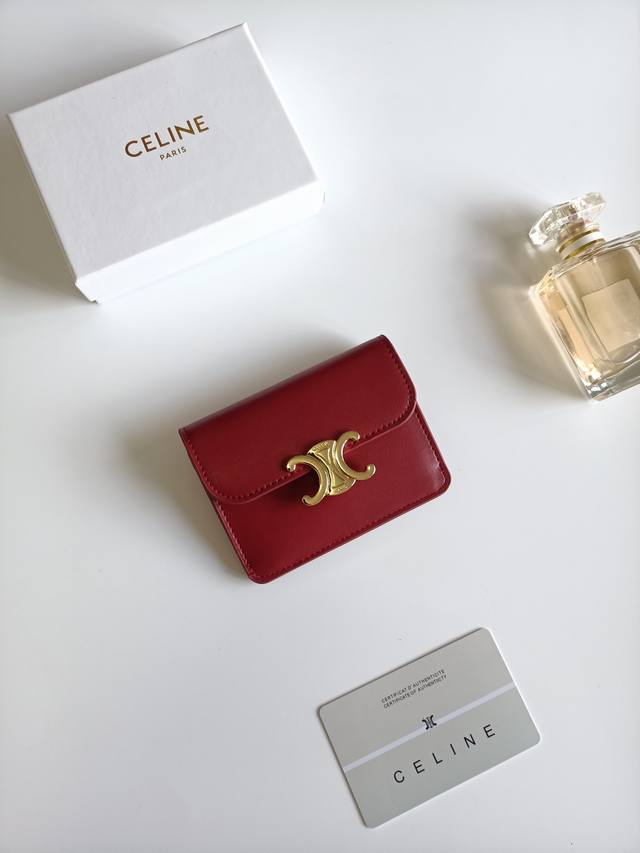 Celine's latest Triomphe leather flap card holder, gold finish, snap button clos
