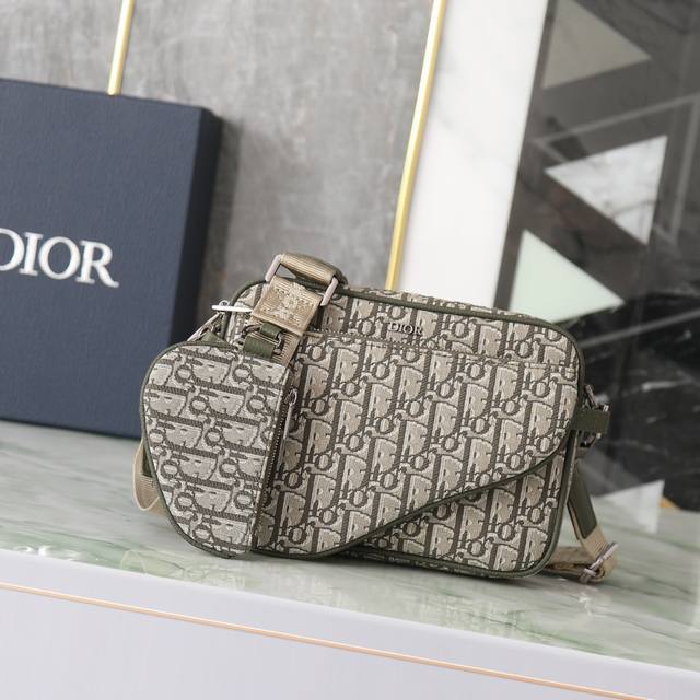 This three-piece Saddle bag is crafted in khaki Oblique print fabric for a strik