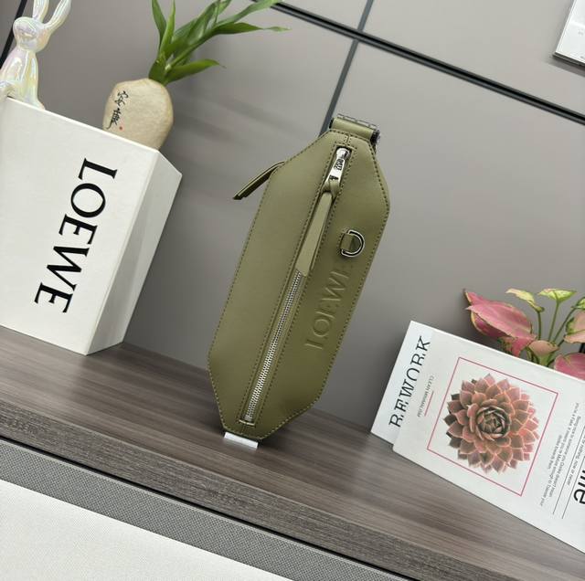 Low Classic Cow Leather Deformed Sling Bag The compact Sling bag features an adj