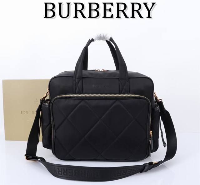 B's super practical diaper bag. Nylon fabric with leather trim. Multiple pockets