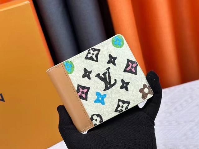 M83334 Beige This Multiple wallet is a Monogram Craggy canvas with a colorful Mo