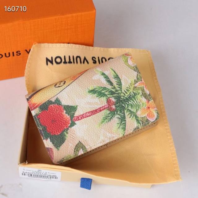 60502 New in Coconut Yellow This beloved pocket wallet is crafted in colorful Mo