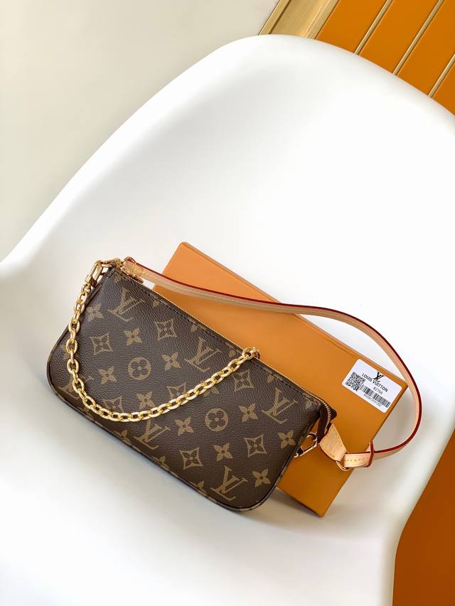 M82766 This Pochette Accessoires handbag is made of Monogram canvas and features