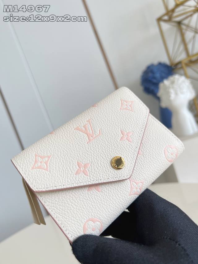 Top original home shot M14967 This Victorine wallet is made of Monogram canvas,