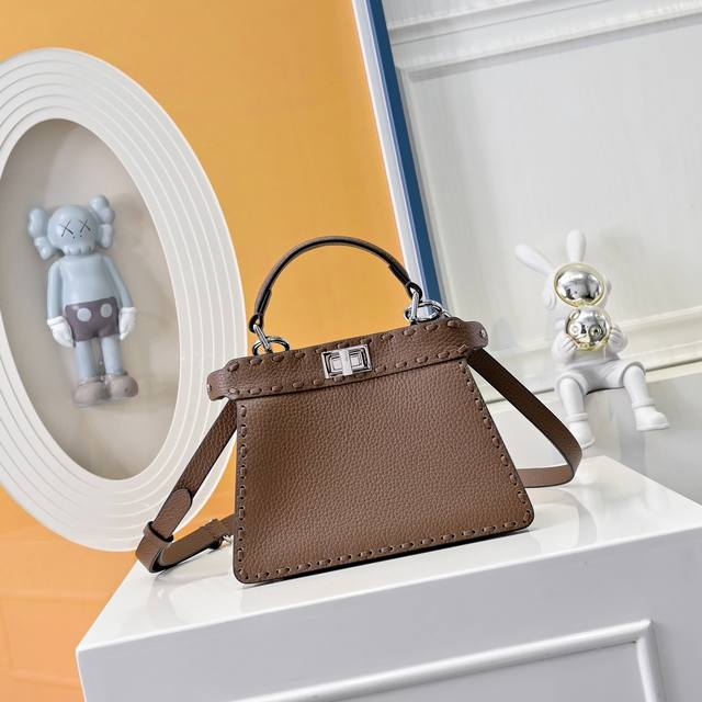 Model 0056 Details: Black hand stitching, medium Peekabooiseeu bag, pebbled cal