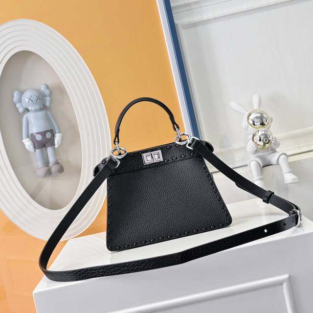 Model 0056 Details: Black hand stitching, medium Peekabooiseeu bag, pebbled cal