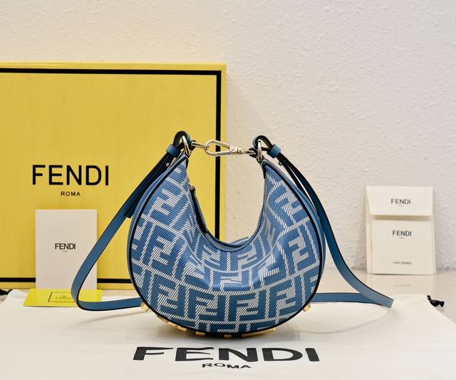 Small blue denim Praphy armpit bag, featuring a crescent shape, with the classi