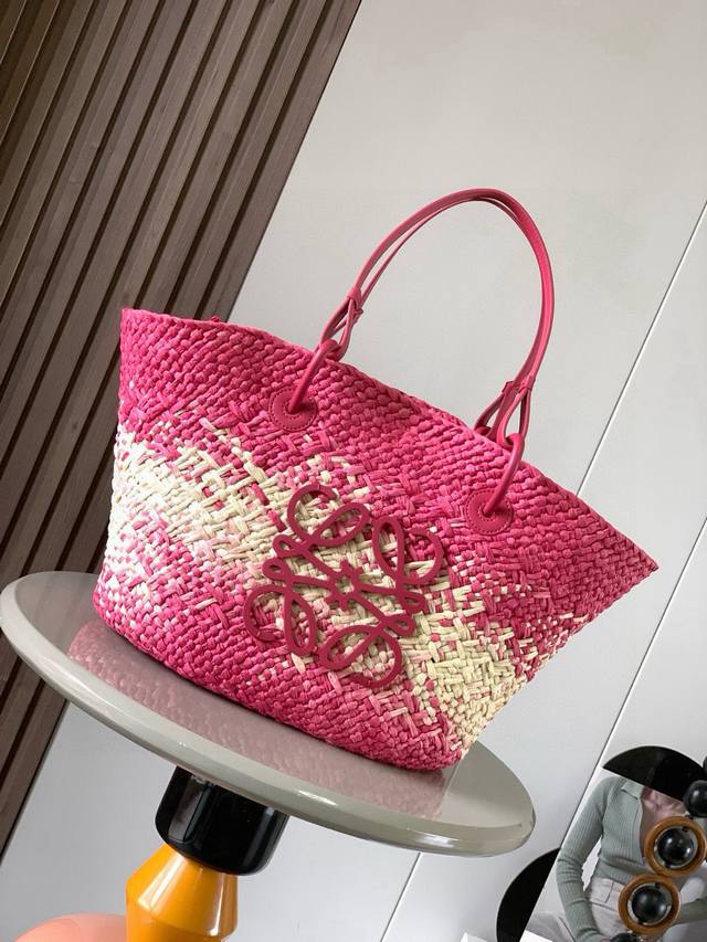 Large Iraca Palm Fiber and Cow Leather Anagram Basket Handbags are worn by many