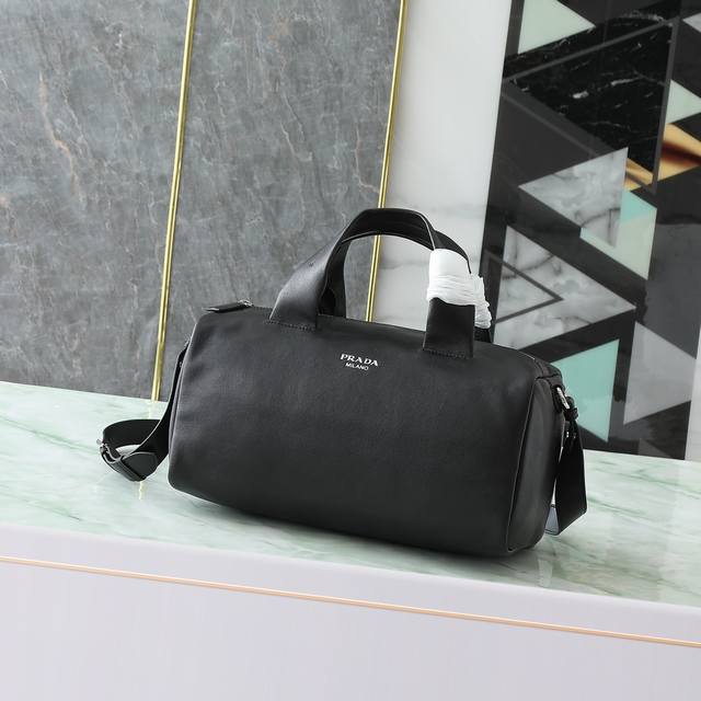 New Black This Nappa leather duffel bag features leather handles and shoulder st