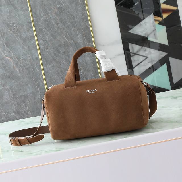 New Suede Coffee Brown This Nappa leather duffel bag features leather handles a