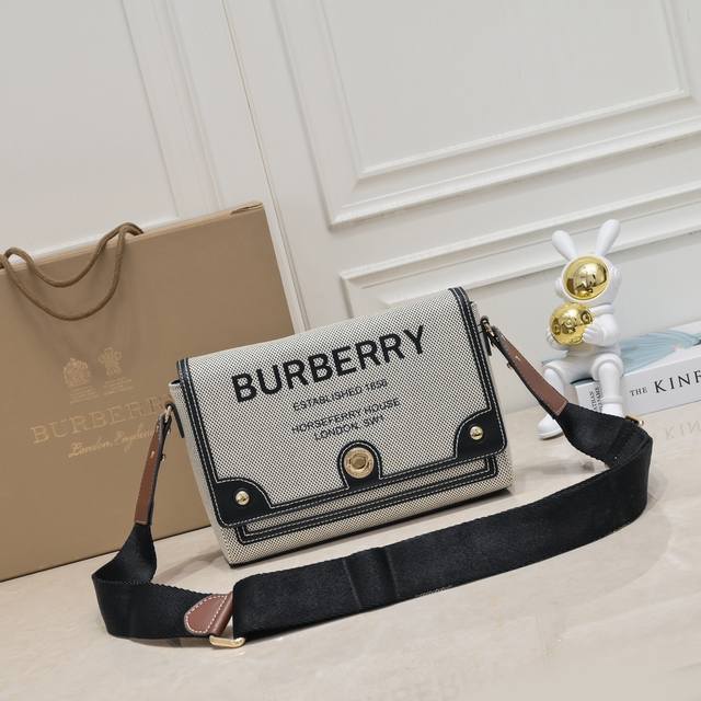 B's exquisite crossbody bag is made of topstitched leather and canvas, decorated
