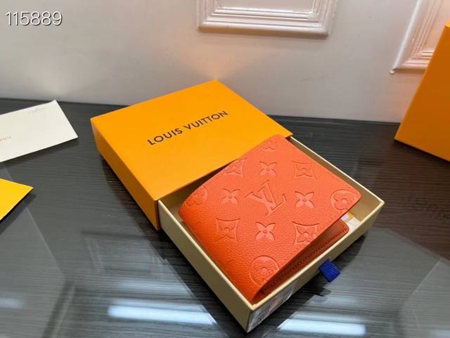 M81548 The orange short clip Multiple wallet has a clean and simple design. The