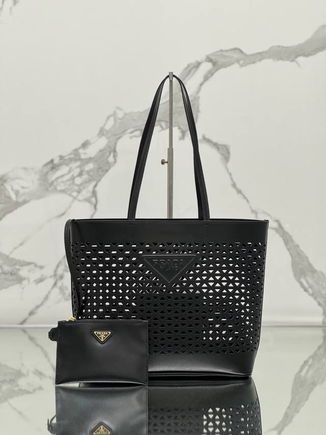 Hollow Tote Shopping Bag. Crafted from imported calfskin, this bag features a st