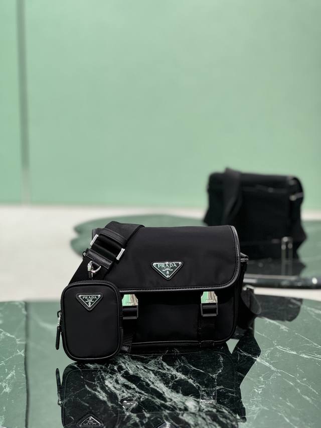 Upgraded small messenger bag featuring the iconic nylon triangle logo. Simple, u