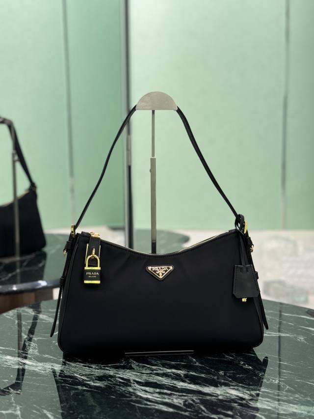 New Nylon Lock Bag. This Tessuto Locker shoulder bag offers a modern and versati