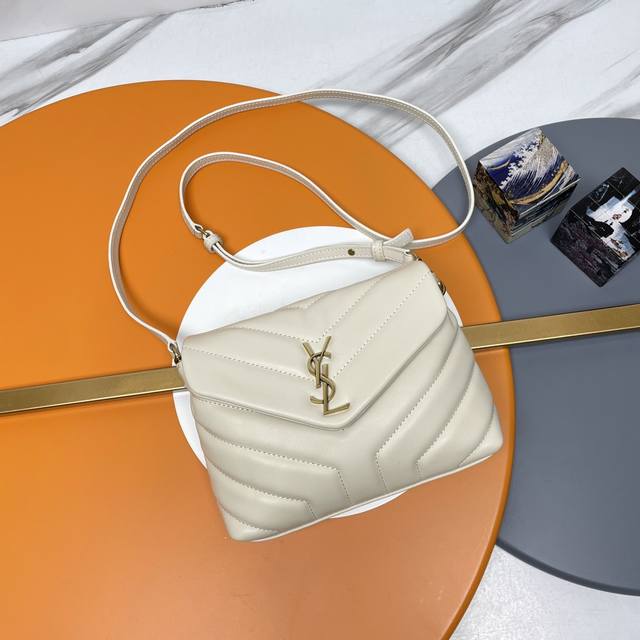 The original version of the original P Loulou mini crossbody bag with a cream-co