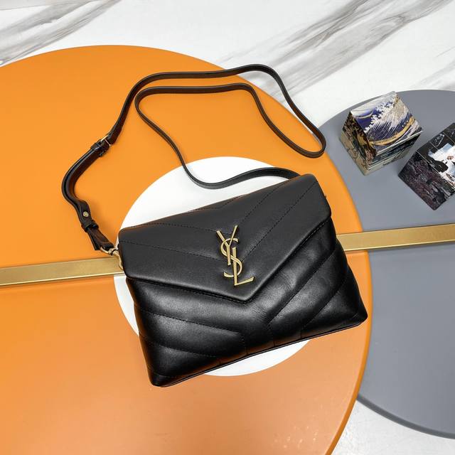 The original version of the black gold-buckle P Loulou mini crossbody bag is her