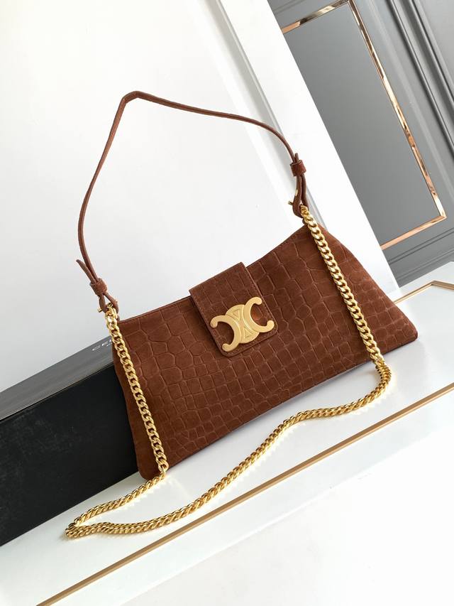 Soft crocodile-embossed suede clutch. This season's must-buy Wiltern Clutch. The