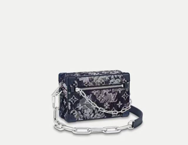 M80033 Mini Soft Trunk Chain Bag is crafted from Monogram Tapestry canvas, delic