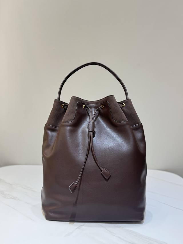 Backpack features a classic brown fabric and leather combination. It comes with