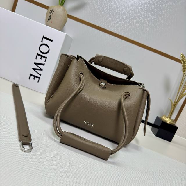 The new small Luojia soft grained cowhide Madrid handbag features a soft, struct