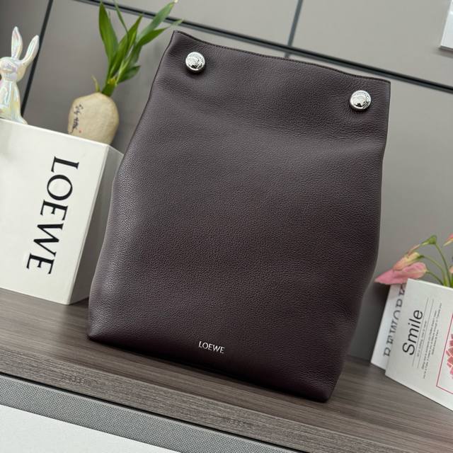 Low Soft Grained Cowhide Pebble Hobo is a minimalist, vertical bag featuring a d