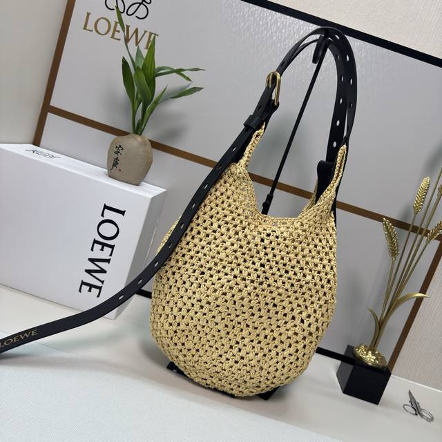 Luojia Punch Hole Hobo straw bag combines a soft hand-woven raffia body with raw