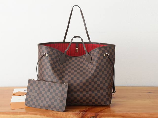 a resizable, chip-enhanced version of the Neverfull Large Tote. Made of Damier E