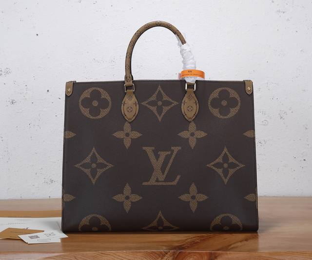 a premium original, enhanced Onthego handbag, features striking Monogram Giant c