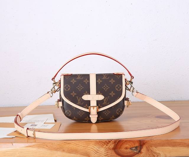 the premium, enhanced Saumur Bb handbag, crafted from Monogram canvas, features