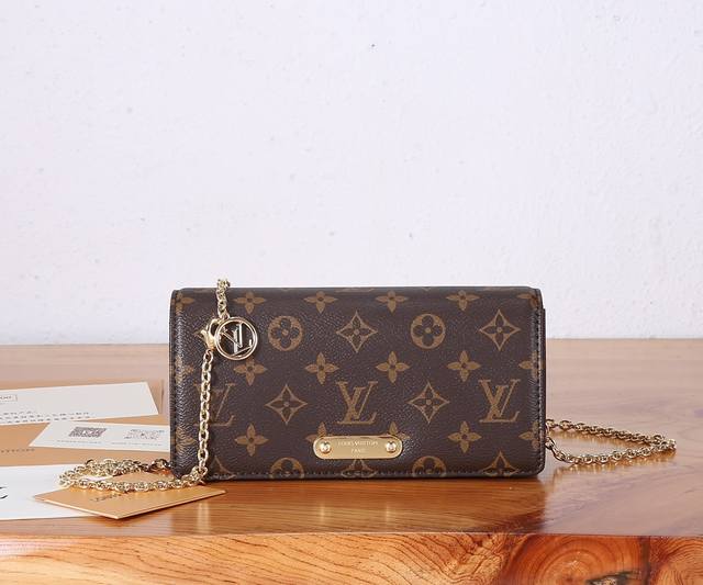 silhouette, features a flap embellished with studs and the Louis Vuitton signatu