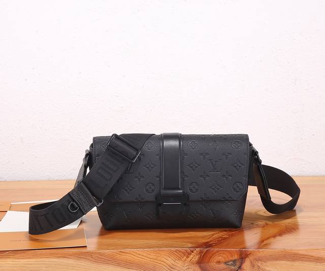 a premium, original, enhanced S-Cape messenger bag crafted from Monogram-embosse