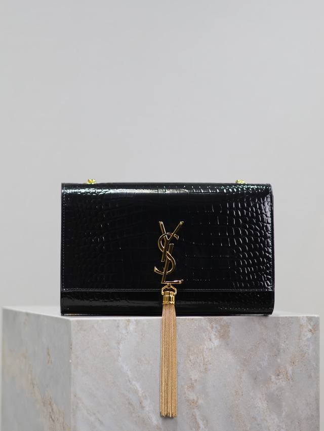 The timeless classic black, gold-buckled, crocodile-patterned Kate 24cm tassel b